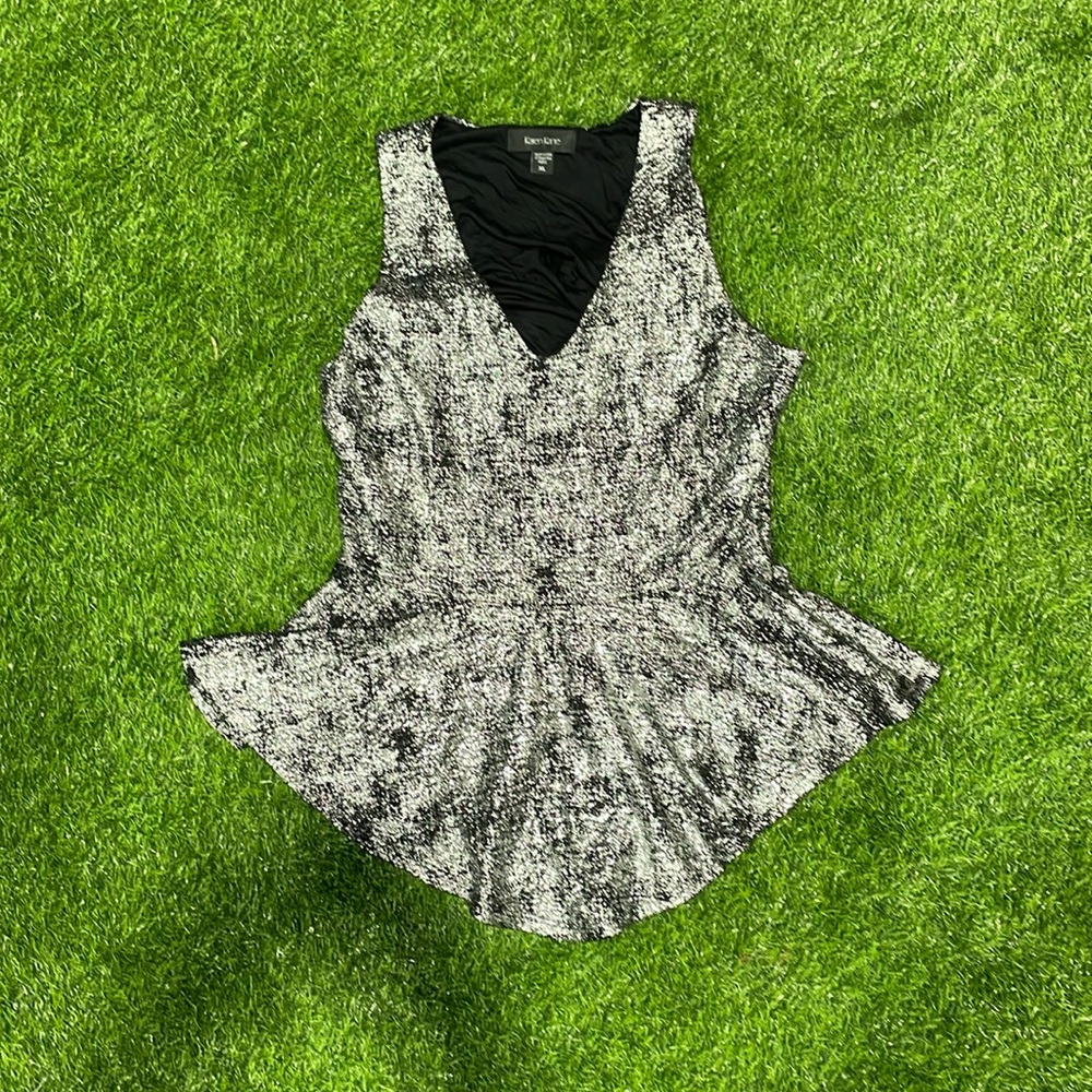 Ladies black and silver sleeveless top with peplum.